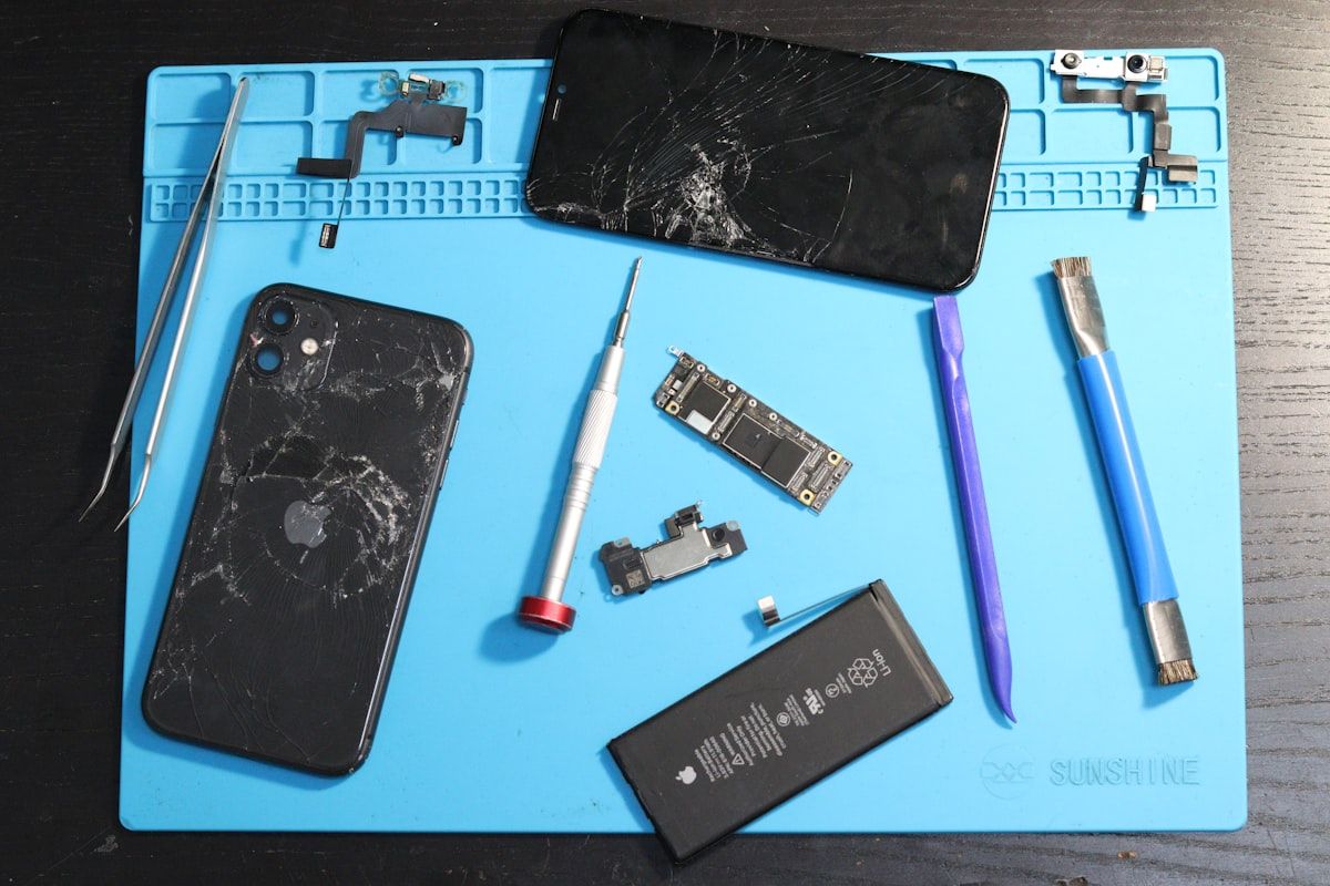 Mobile phone batteries and replacement parts on a repair bench